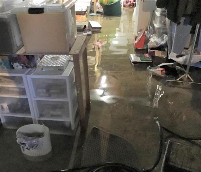 A flooded concrete floor in a basement room